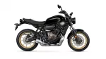 Side view of a black Yamaha motorcycle with gold alloy wheels and visible engine.