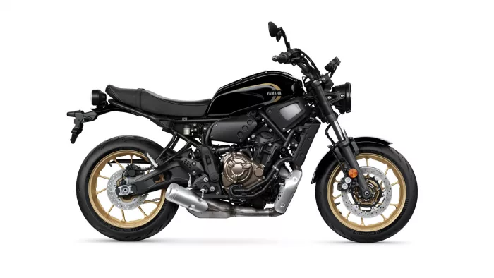 Side view of a black Yamaha motorcycle with gold alloy wheels and visible engine.