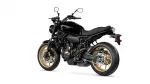 Side view of a black Yamaha sport motorcycle with gold alloy wheels.