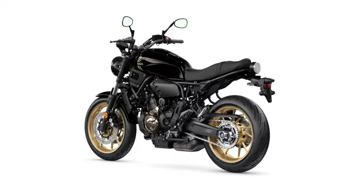 Side view of a black Yamaha sport motorcycle with gold alloy wheels.