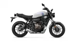 Side view of a white Yamaha motorcycle with black frame and exposed engine on a white background