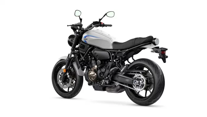 White Yamaha sport motorcycle shown from the left-rear side, highlighting the silver gas tank and black chassis.