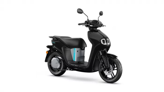 Black modern scooter with teal accent panel, side view angled, front wheel visible and headlight area prominent