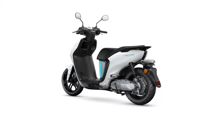 White and black scooter shown from a rear-left angle, exposing the rear wheel and seat area (informative product image).