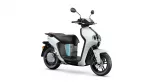 Front three-quarter view of a white and gray modern scooter with black seat and teal accent stripe on the body.