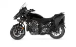 Side view of a black Yamaha adventure motorcycle with integrated side panniers and clear windscreen.