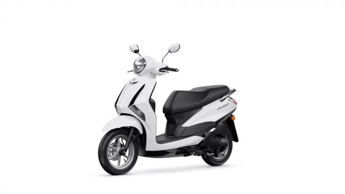 White scooter shown from a side-front angle with headlight, chrome mirrors, and a black seat.