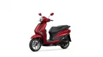 Red scooter shown from a front-right angle with headlight and mirrors on a white background, partial view of the front wheel and seat.