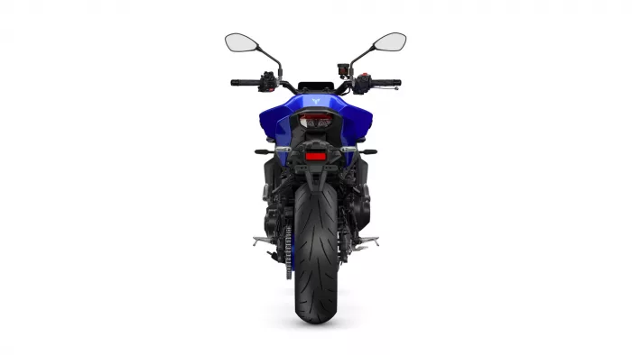 Rear view of a blue sport motorcycle with wide rear tire and mirrors on white background.