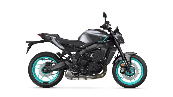 Side view of a gray/black sport motorcycle with bright teal rims and exposed engine components, Yamaha logo visible on the fuel tank.