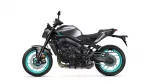 Side view of a modern sport motorcycle with teal rims and a gray-black body, showcasing its exposed engine and sleek design.