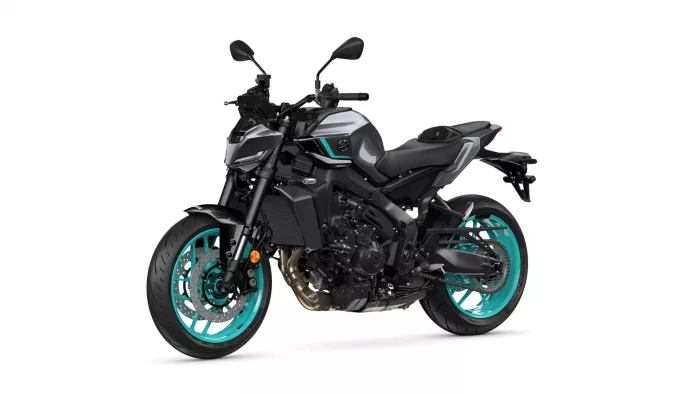 Sport motorcycle in a three-quarter view with black body, teal accents and turquoise wheels, facing left side on white background