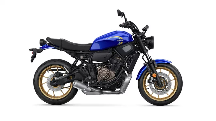 Blue Yamaha motorcycle shown in profile with gold wheels and exposed engine; sporty street bike view.
