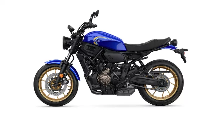Blue Yamaha street bike shown in profile with a gold-rimmed wheel and exposed engine components
