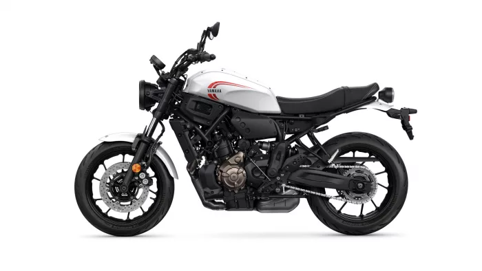 White Yamaha motorcycle shown in left-side profile with exposed engine and black frame, logo on the fuel tank, and rear rack against a white background.