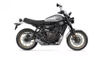 Side view of a Yamaha XSR700 motorcycle with a silver fuel tank and gold wheels, shown in profile.