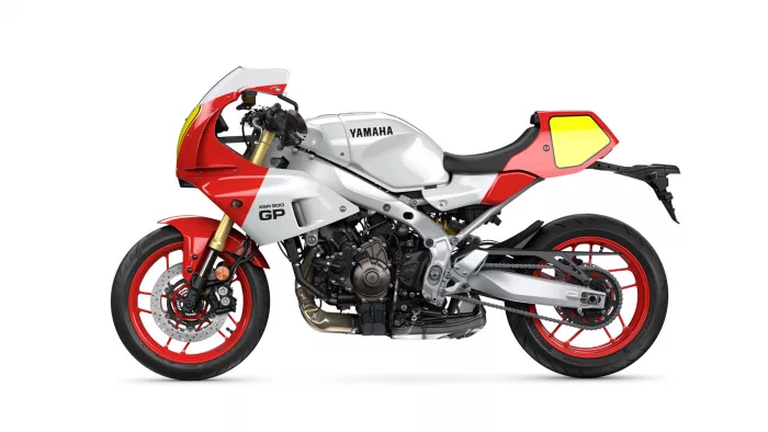 Side view of a Yamaha sport motorcycle in white and red, with red wheels and visible engine details.