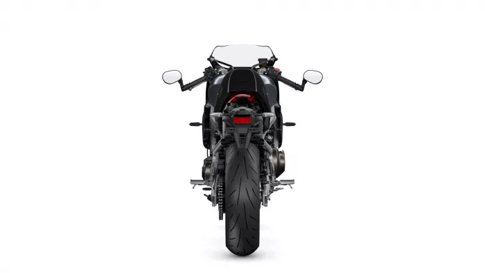 Rear view of a black sport motorcycle, showing taillight, mirrors, and wide rear tire against a white background.",