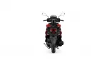 Rear view of a red and black motorcycle, showing tail light and rear wheel against a white background.