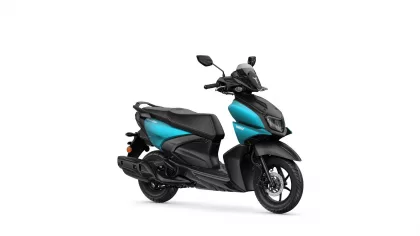 Turquoise-and-black Yamaha scooter shown from a side-front angle, highlighting its sporty design and windscreen