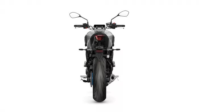 Rear view of a sport motorcycle, showing the back wheel, tail light, and dual mirrors.