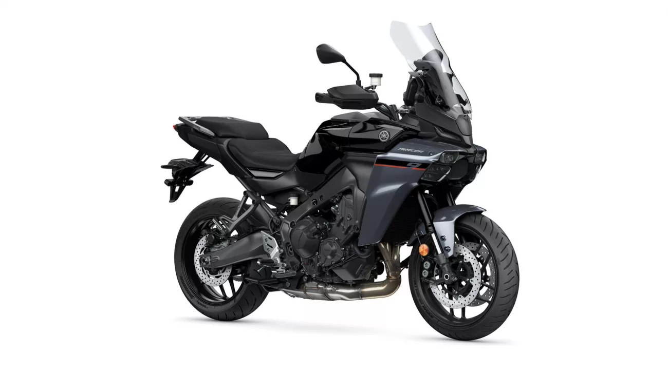 Black Yamaha Tracer sport-touring motorcycle shown from a front-right three-quarter view, with a tall windshield and exposed engine.