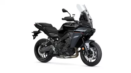 Black Yamaha Tracer sport-touring motorcycle shown from a front-right three-quarter view, with a tall windshield and exposed engine.