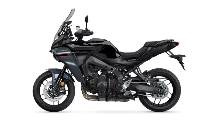 Side view of a black Yamaha adventure motorcycle with windshield and exposed engine details