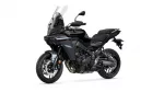 Sport-touring motorcycle viewed from the front-left, featuring a tall windshield and dual headlights for an aggressive touring bike look.