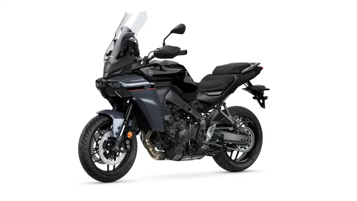 Sport-touring motorcycle viewed from the front-left, featuring a tall windshield and dual headlights for an aggressive touring bike look.