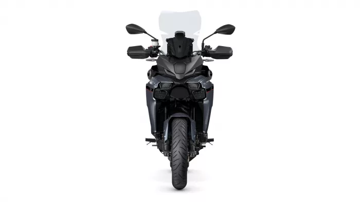 Front view of a dark gray adventure motorcycle with a tall windscreen, mirrors, and dual headlights