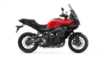 Red Yamaha Tracer 9 sport-touring motorcycle shown in profile with a large windshield and black accents on a white background.