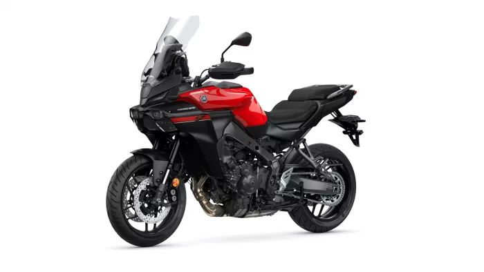Front-left profile of a red Yamaha Tracer sport-tourer motorcycle with a tall windshield and black chassis, ready for ride.