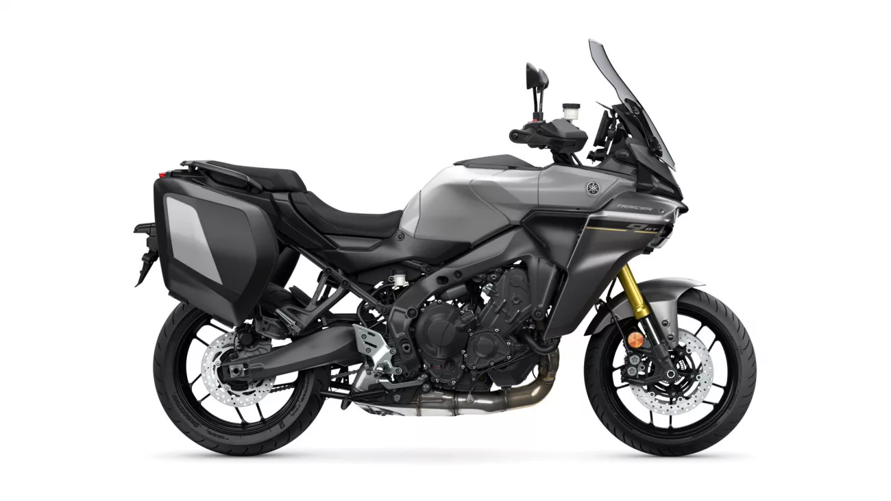 Side view of a gray sport-touring motorcycle with black hard panniers and a tall windshield.