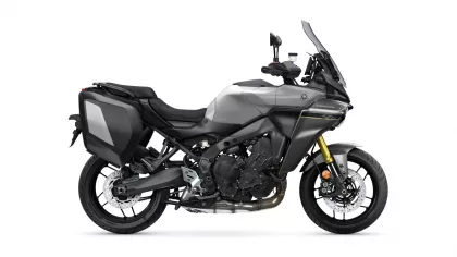 Side view of a gray sport-touring motorcycle with black hard panniers and a tall windshield.