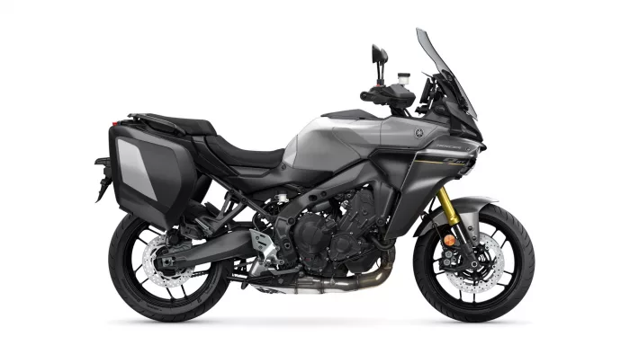 Side view of a gray sport-touring motorcycle with black hard panniers and a tall windshield.