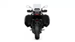 Rear view of a black adventure motorcycle with side panniers and a tall windshield on a white background