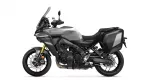 Gray Yamaha adventure motorcycle with a tall windshield and black hard side cases mounted on the rear.