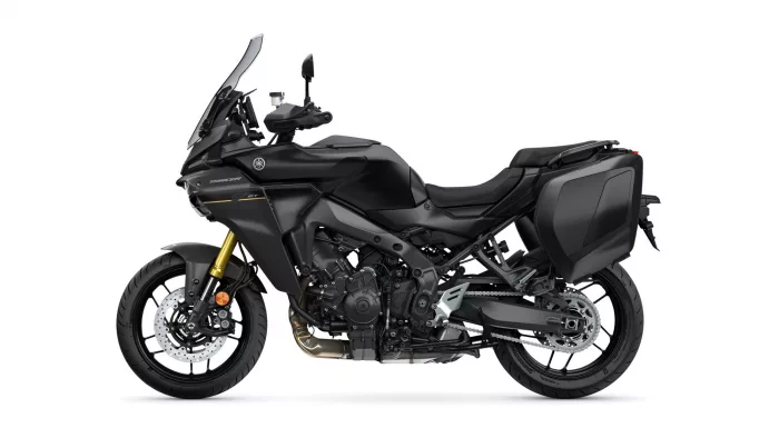 Black Yamaha Tracer GT sport-touring motorcycle with side panniers and tall windscreen viewed in profile.
