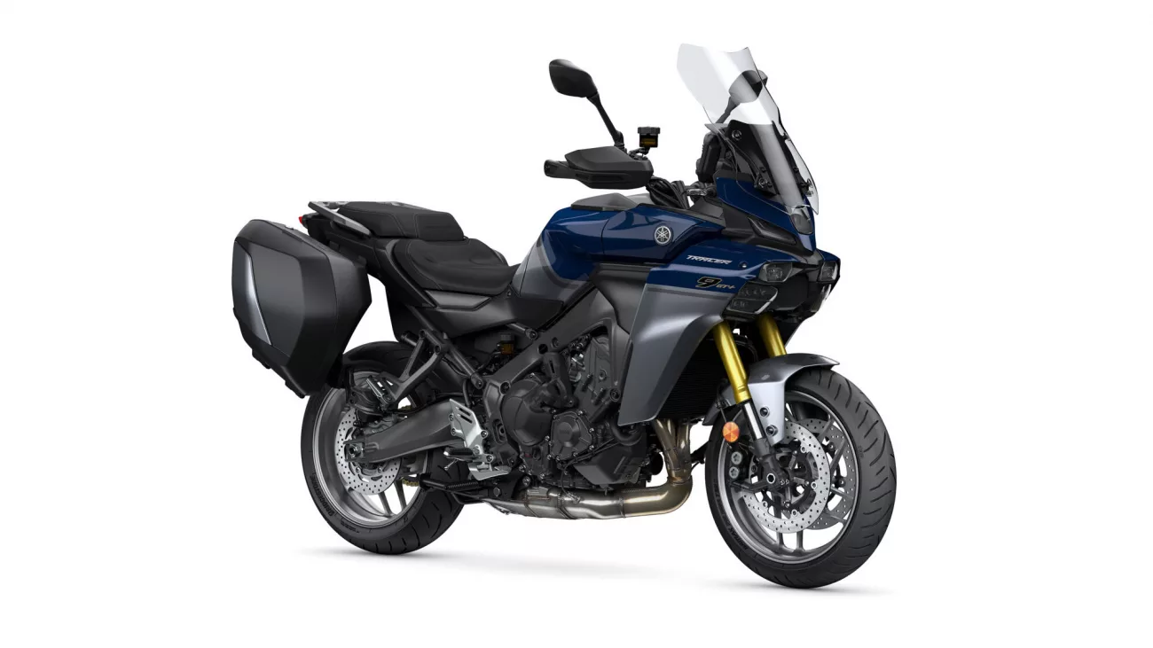 Blue Yamaha Tracer touring motorcycle shown in side view with hard panniers and tall windshield (front-right angle)