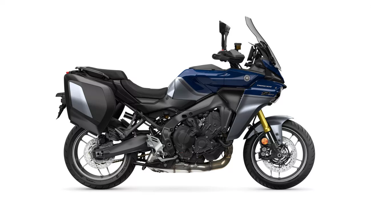Blue Yamaha Tracer sport-t touring motorcycle with hard side cases, shown in side profile from the left, windshield up