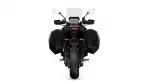 Rear view of a black motorcycle with large side panniers, a tall windshield, and a central taillight on a white background.
