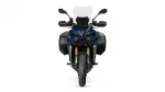 Front view of a blue adventure motorcycle with windshield, side panniers, and bold styling.