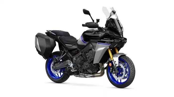 Adventure sport motorcycle with side panniers and tall windscreen, blue rims, on a white background.
