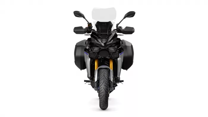 Front view of a black adventure motorcycle with panniers, windscreen, and gold front forks facing forward