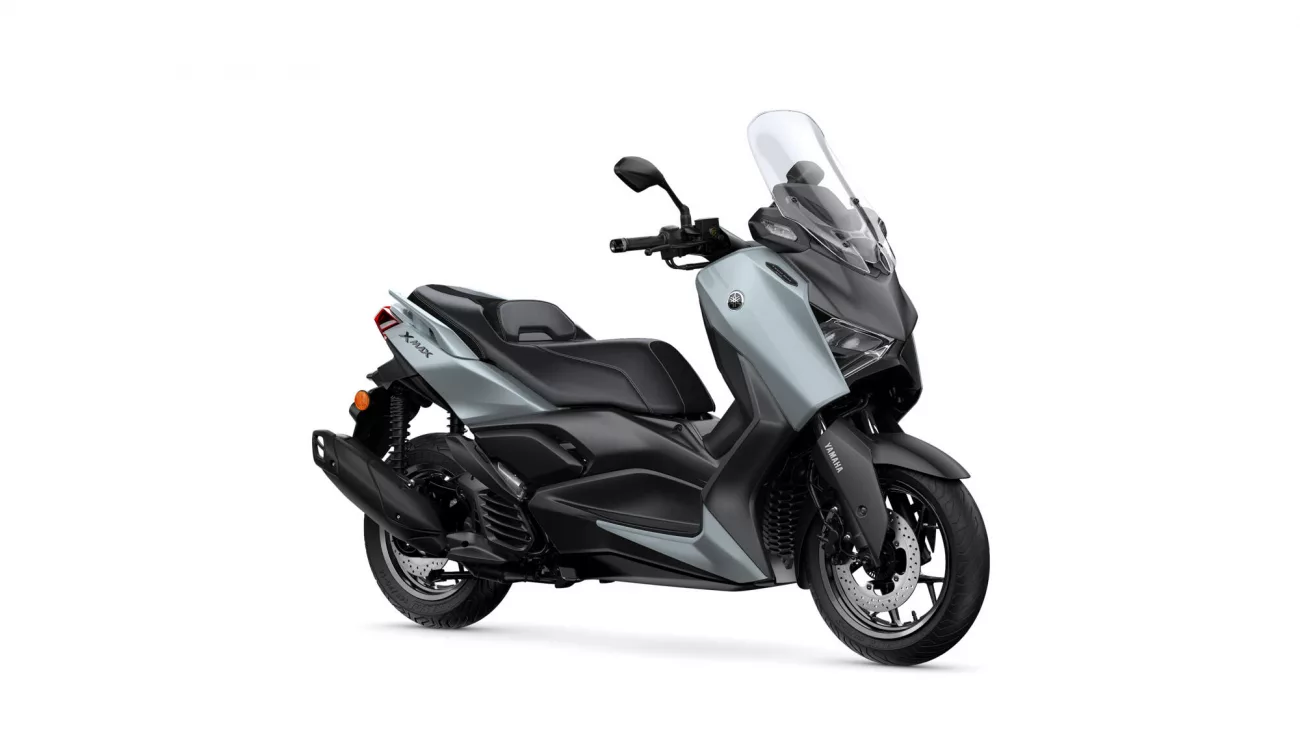 Side view of a gray Yamaha XMAX scooter with a tall clear windshield and black seat.