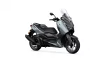 Side view of a gray Yamaha XMAX scooter with a tall clear windshield and black seat.