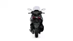 Rear view of a modern sport motorcycle with a tall windshield and red taillights