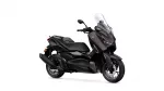 Dark brown Yamaha scooter with a tall clear windshield, shown from a front-right angle.