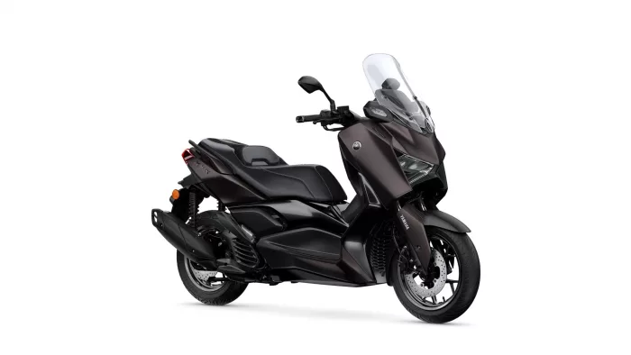 Dark brown Yamaha scooter with a tall clear windshield, shown from a front-right angle.
